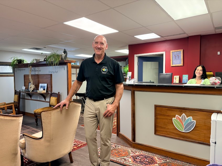 Dr. Paul Given at the front desk of Rejuve-Nation Wellness Clinic in Kingston
